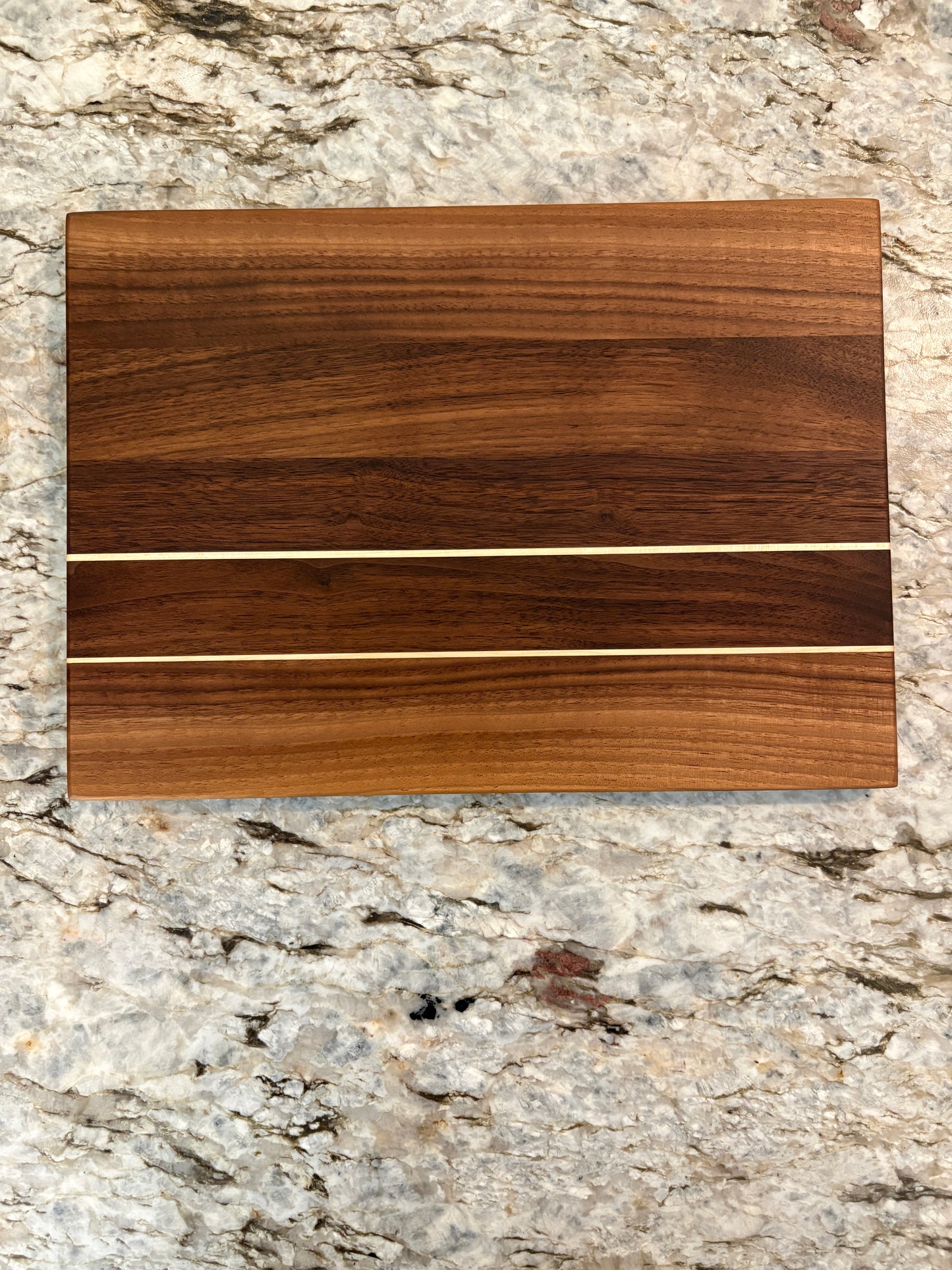 Walnut cutting board with Maple accent strips