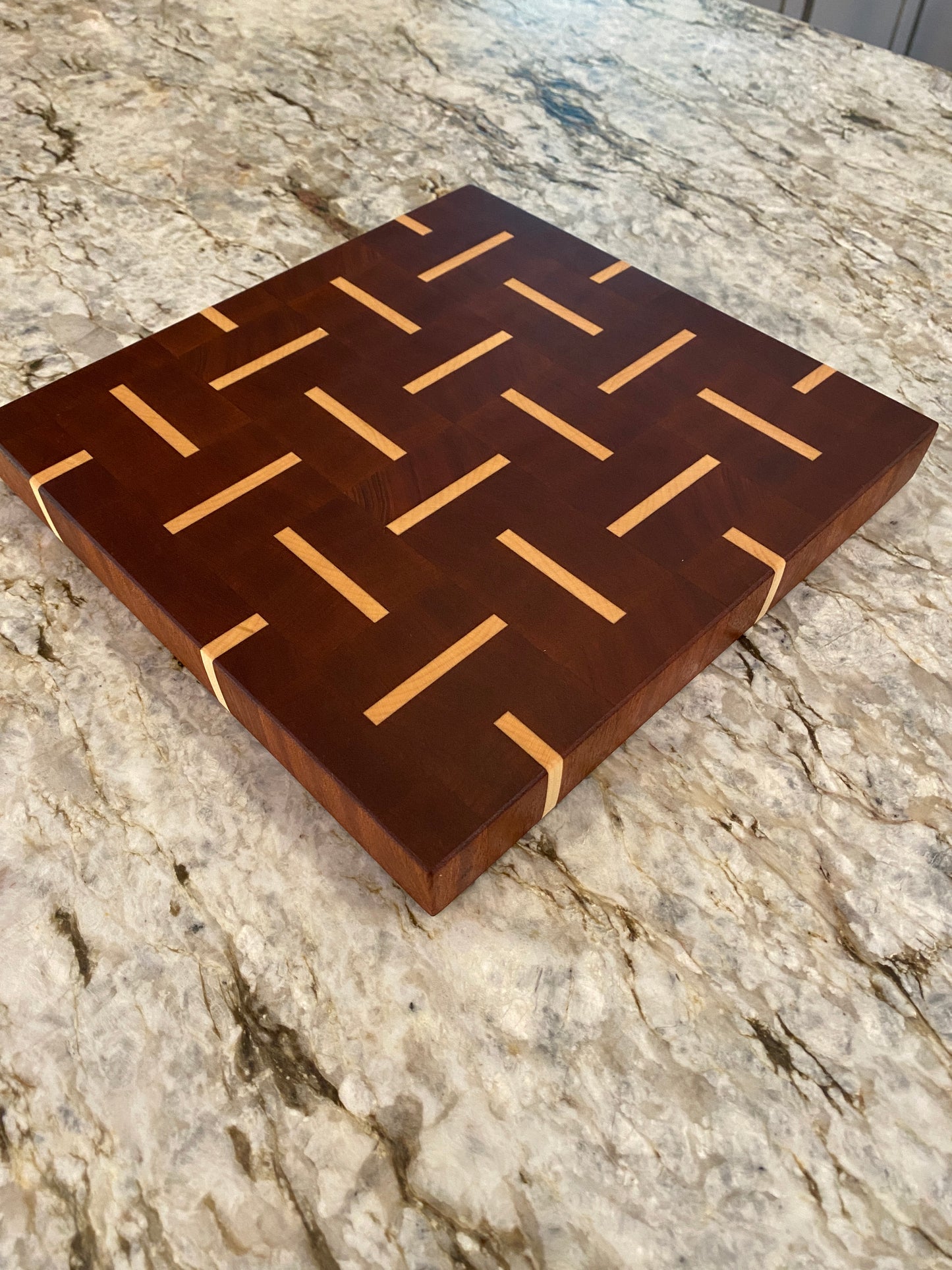 Sapelle end grain cutting board with Maple basketweave