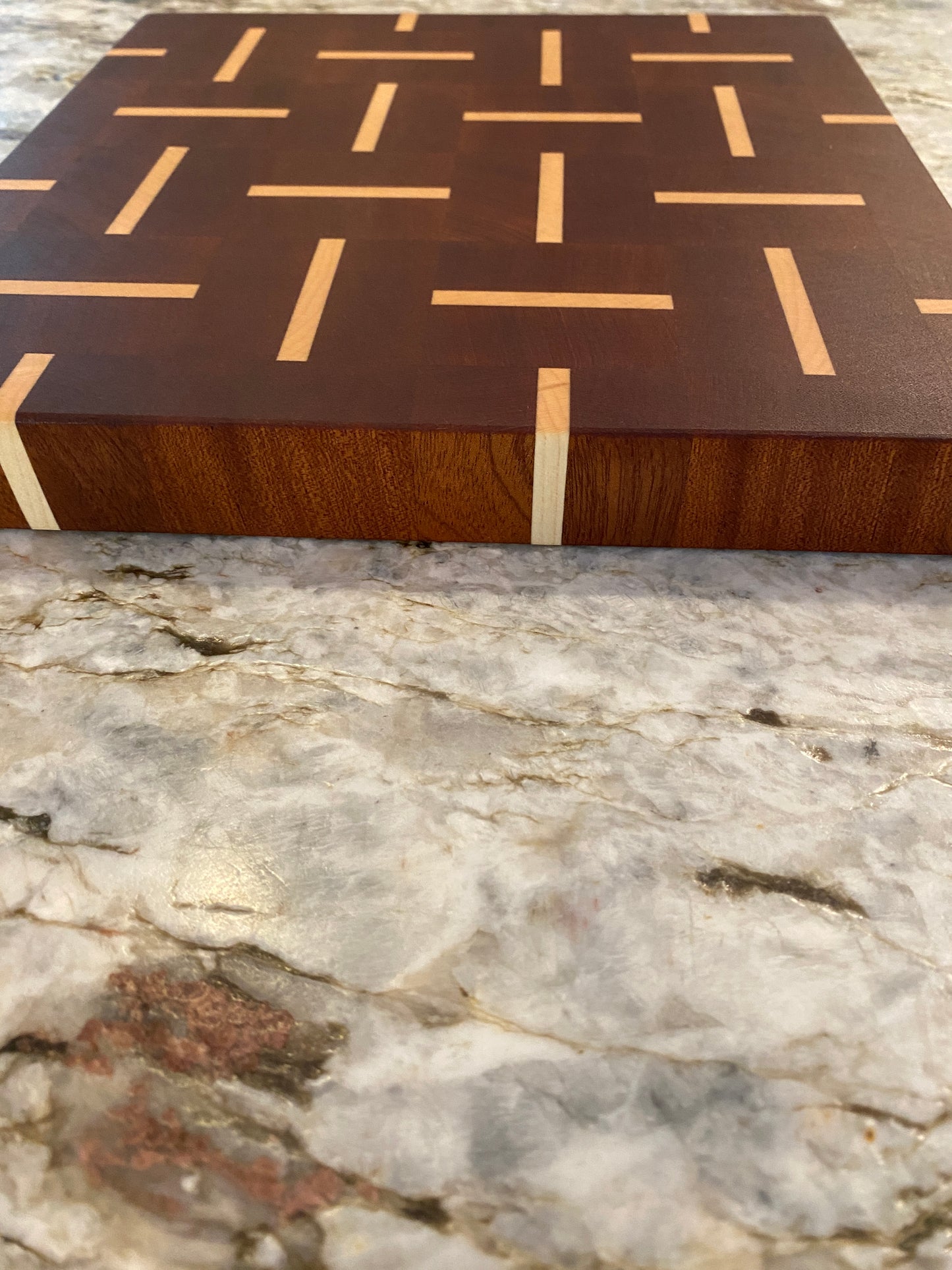 Sapelle end grain cutting board with Maple basketweave