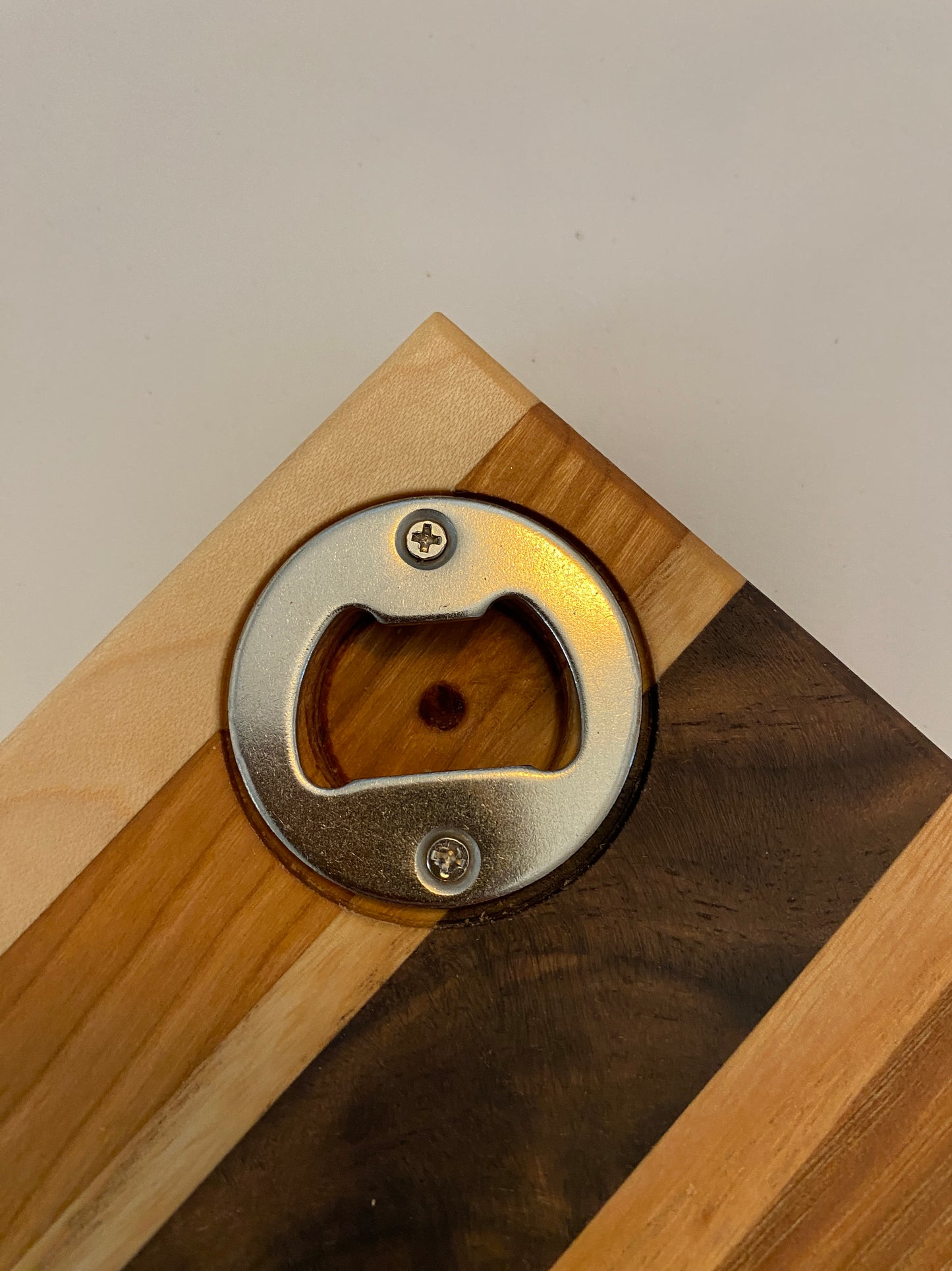 Coaster with built in bottle opener