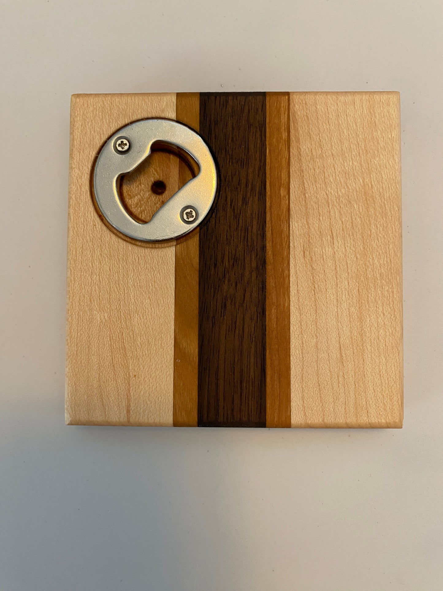 Coaster with built in bottle opener