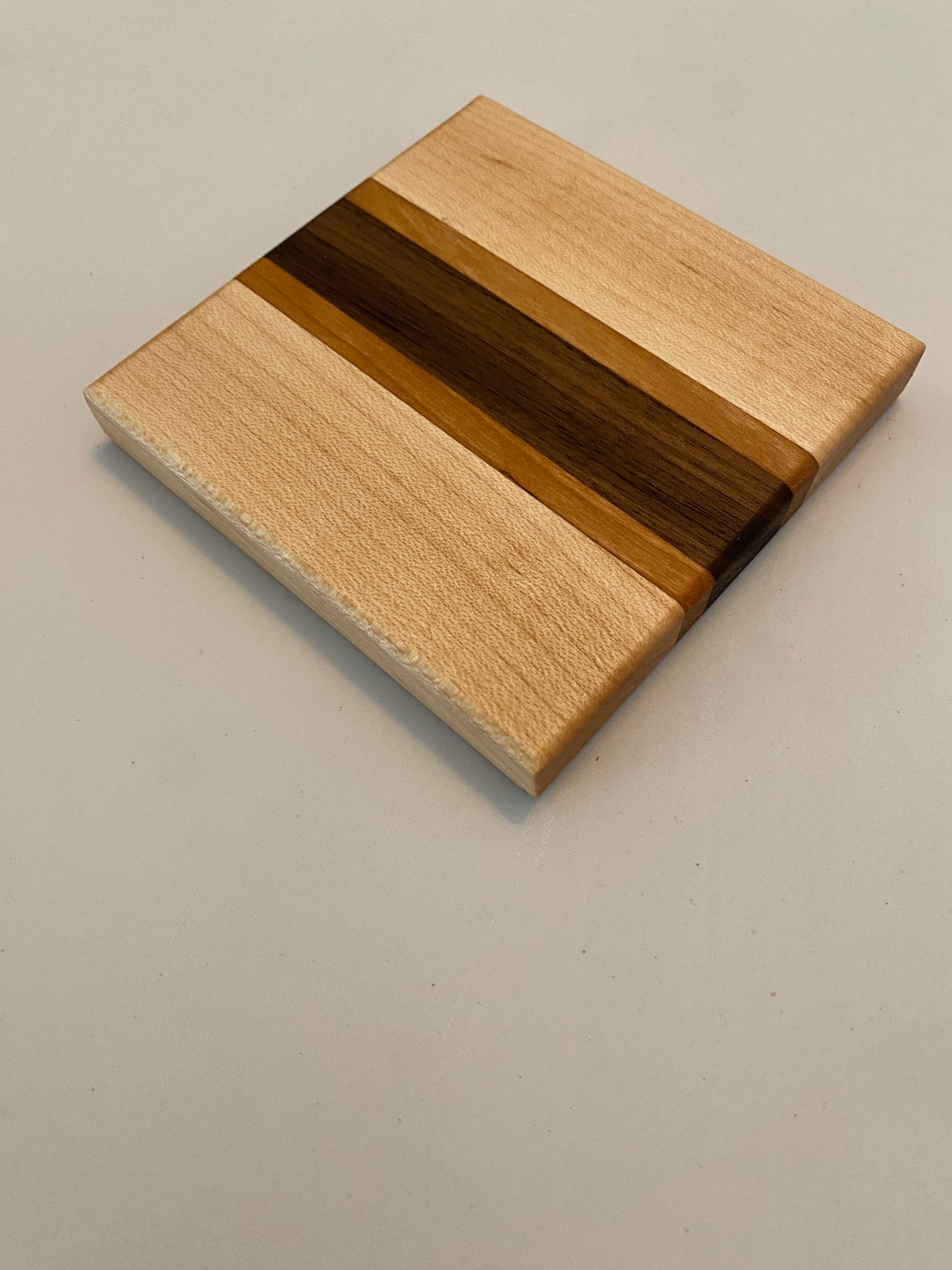 Coaster with built in bottle opener