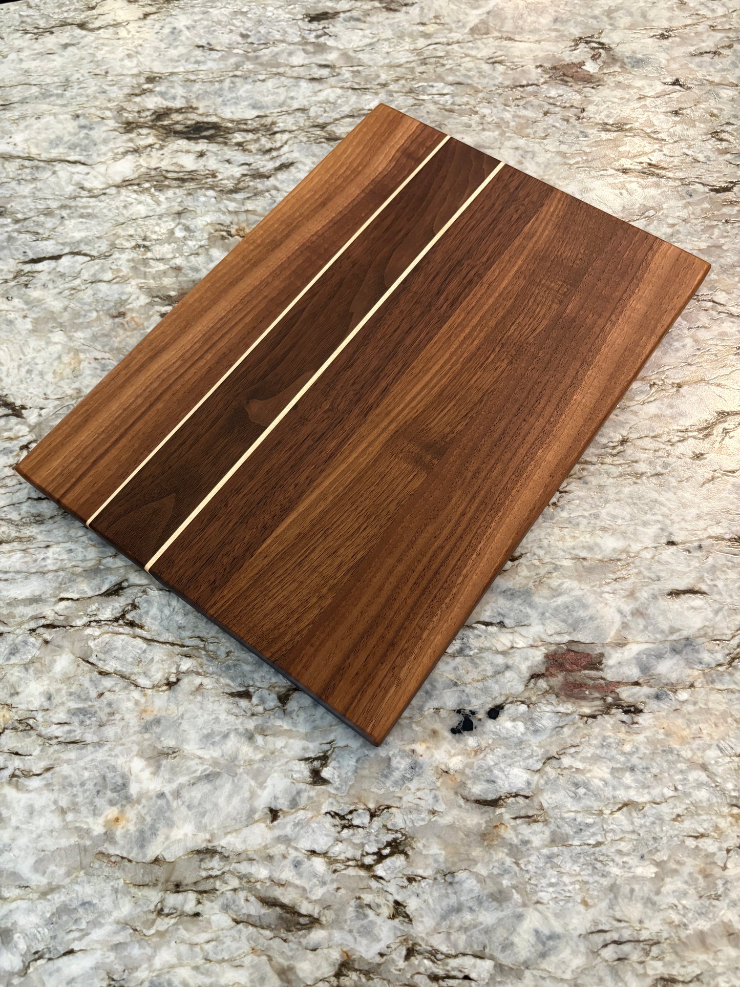 Walnut cutting board with Maple accent strips