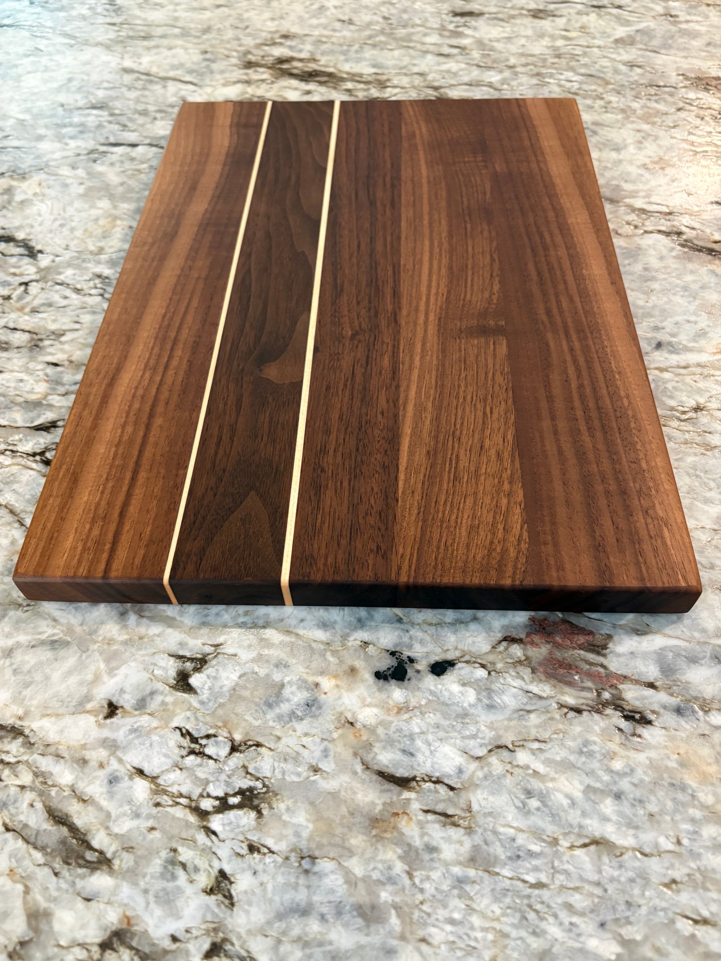 Walnut cutting board with Maple accent strips