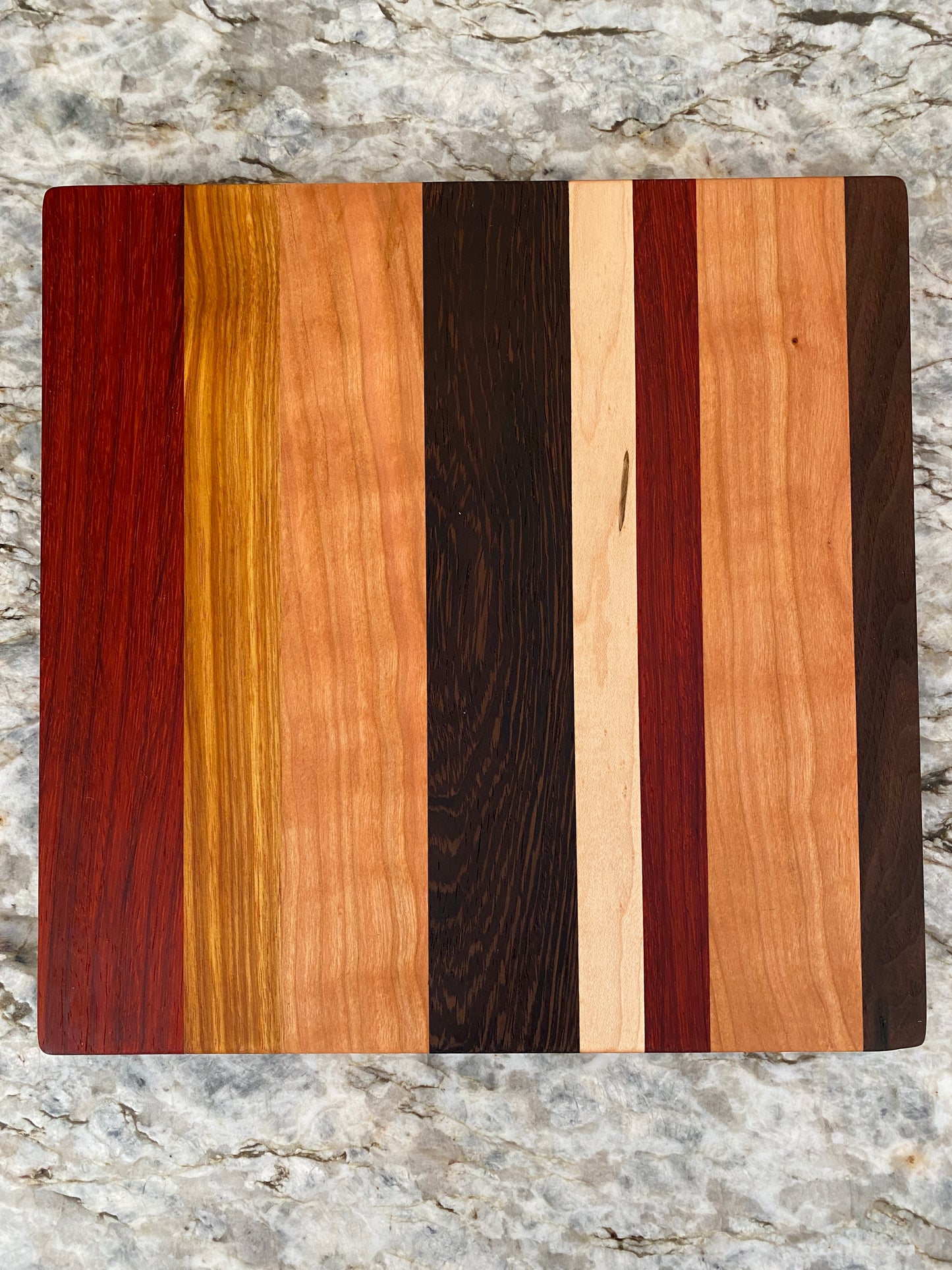 Padauk, Canary, Wenge, Birdseye Maple, Walnut, and Cherry cutting board