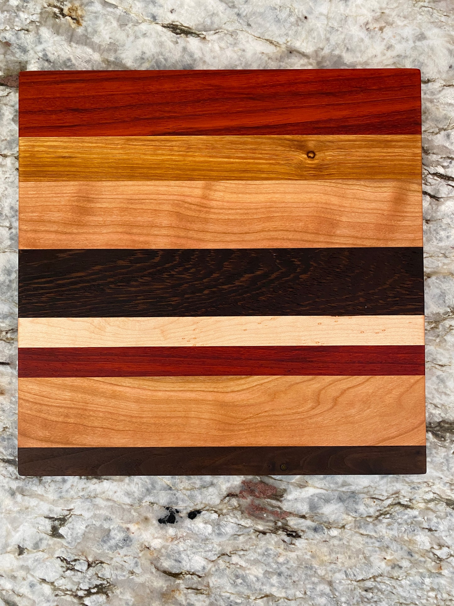 Padauk, Canary, Wenge, Birdseye Maple, Walnut, and Cherry cutting board