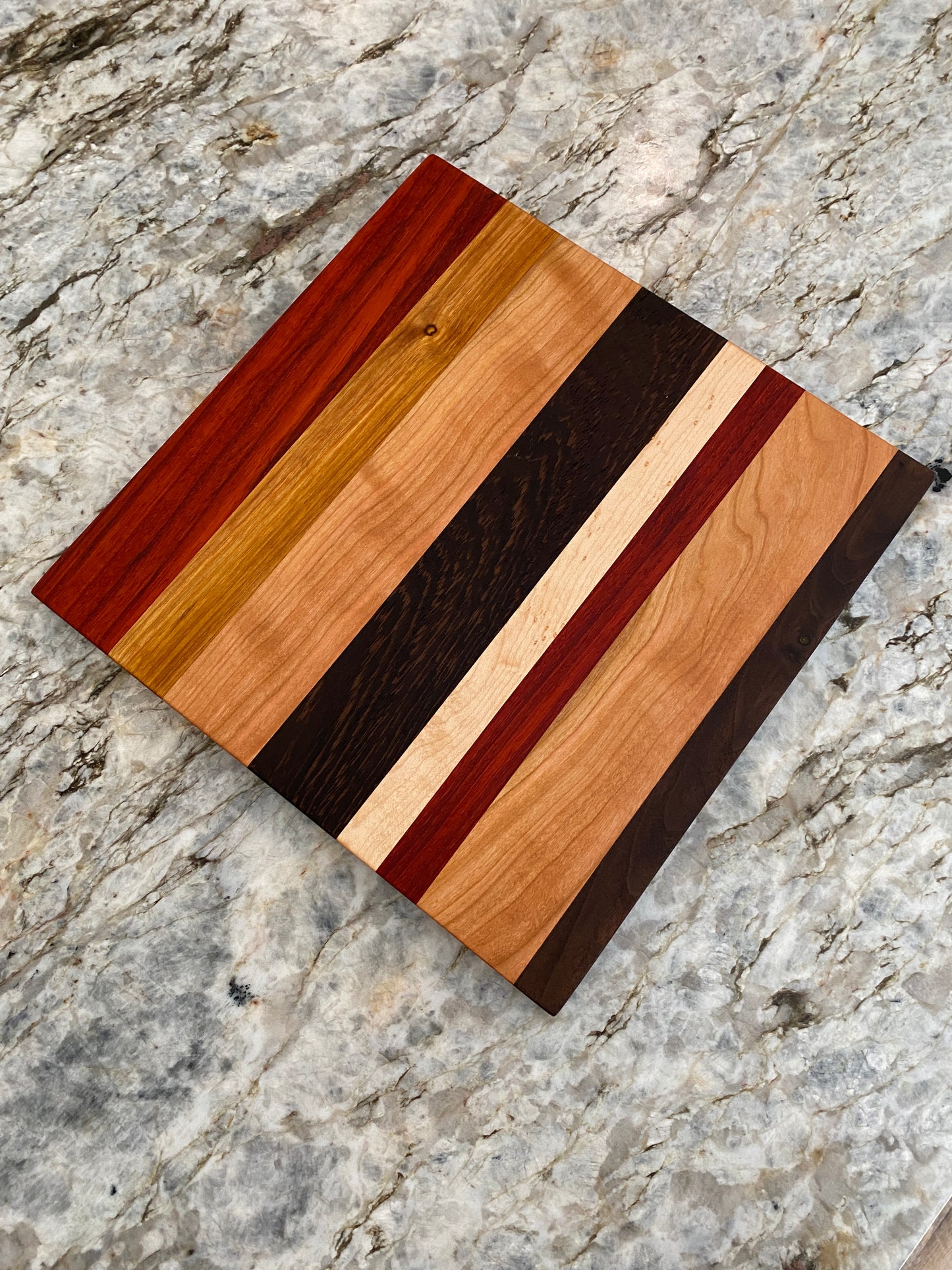 Padauk, Canary, Wenge, Birdseye Maple, Walnut, and Cherry cutting board