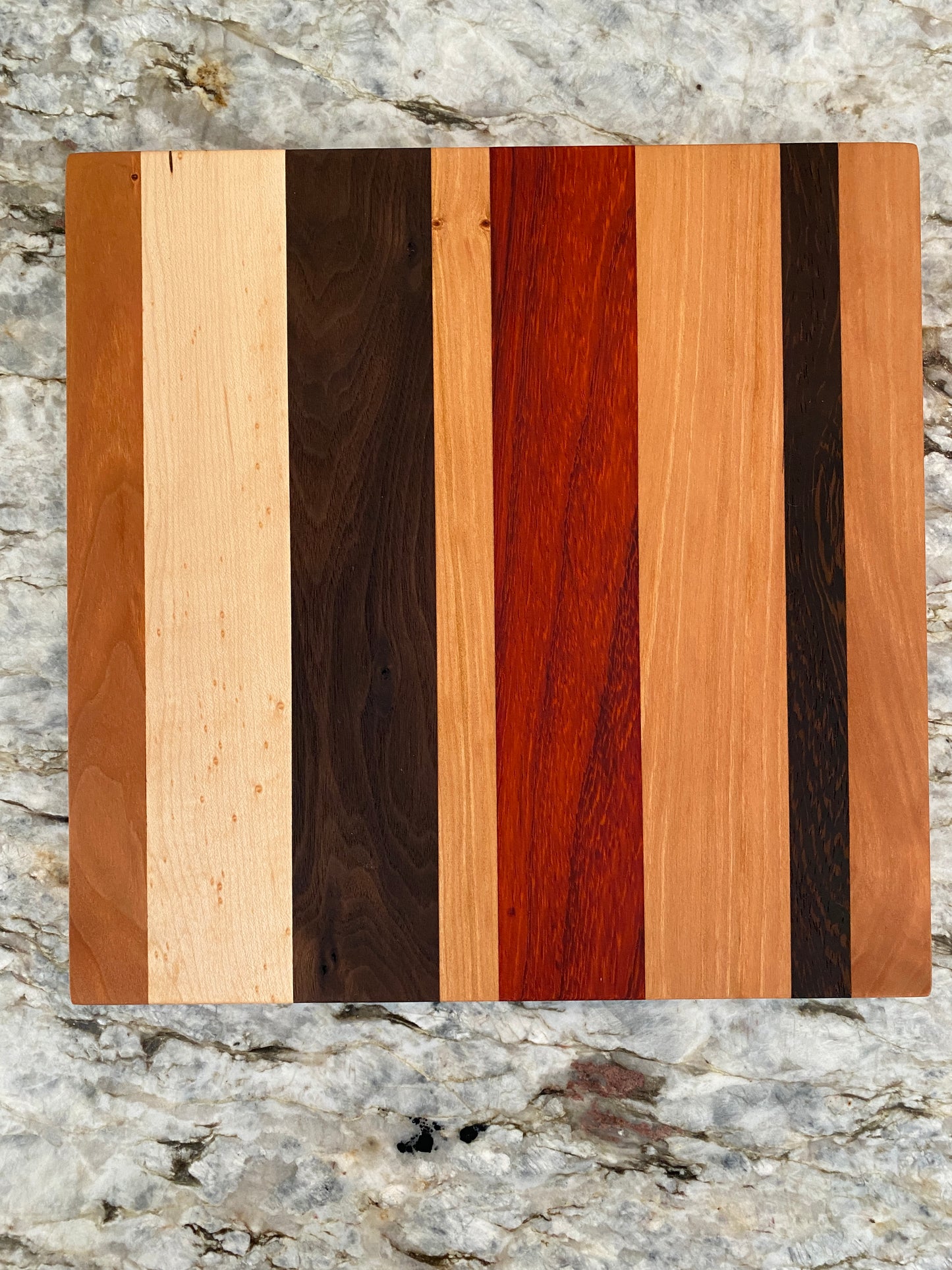 Padauk, Canary, Wenge, Birdseye Maple, Walnut, and Cherry cutting board