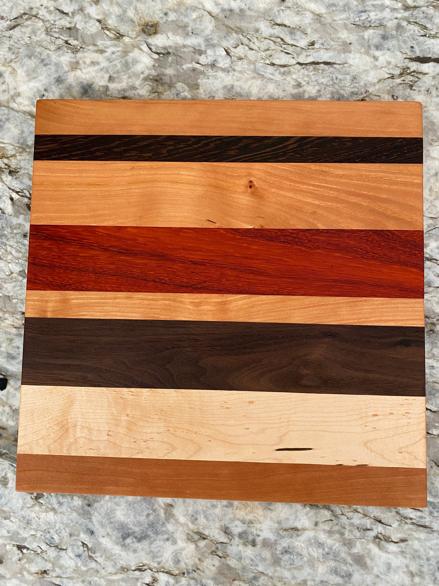 Padauk, Canary, Wenge, Birdseye Maple, Walnut, and Cherry cutting board