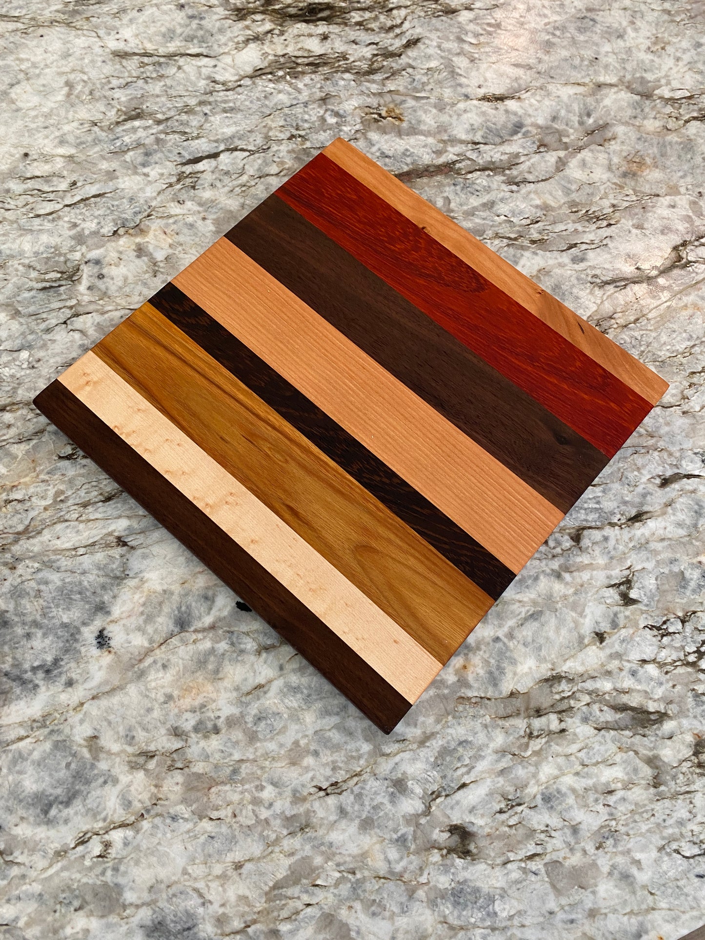 Padauk, Canary, Wenge, Birdseye Maple, Walnut, and Cherry cutting board