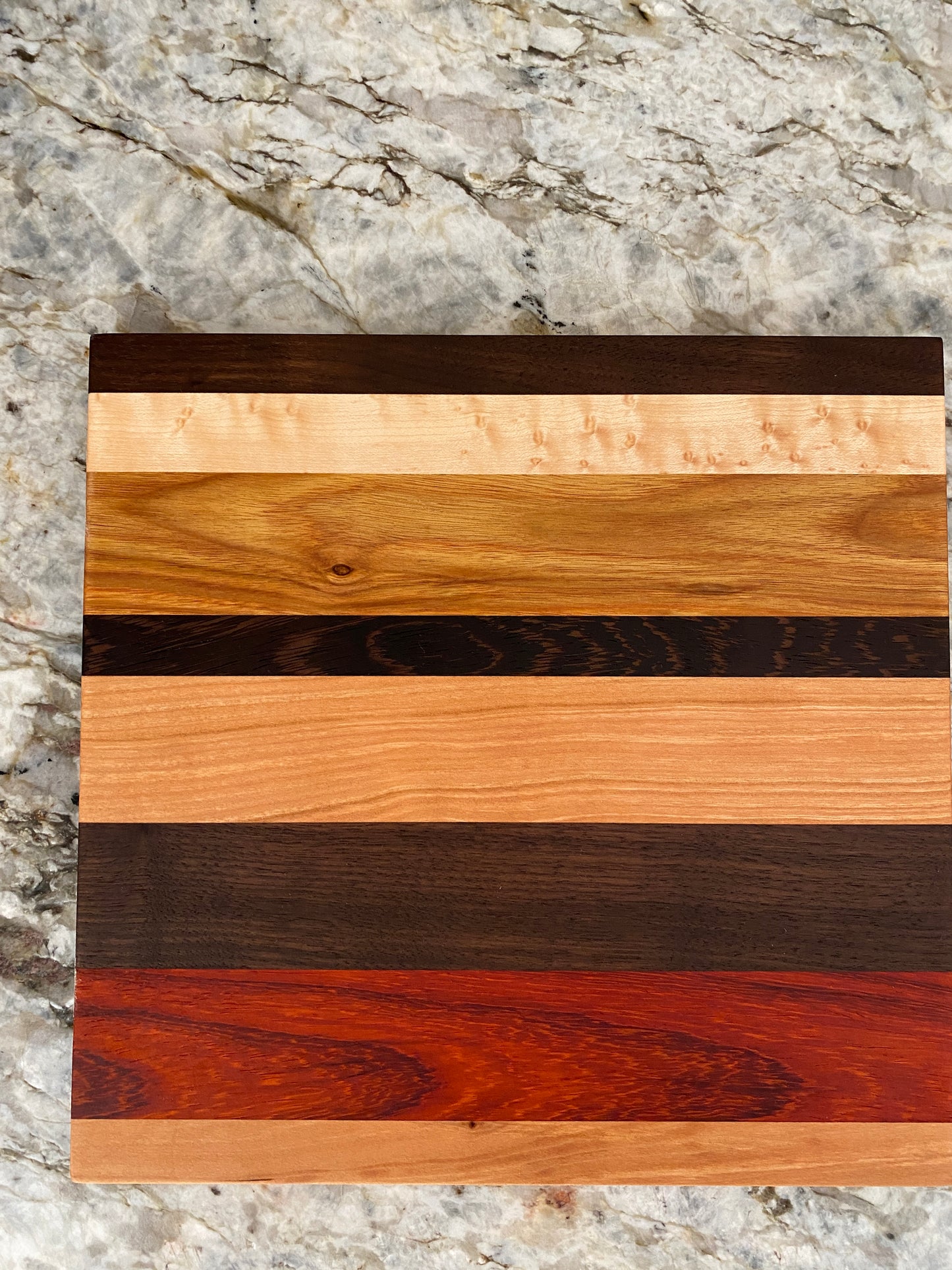 Padauk, Canary, Wenge, Birdseye Maple, Walnut, and Cherry cutting board