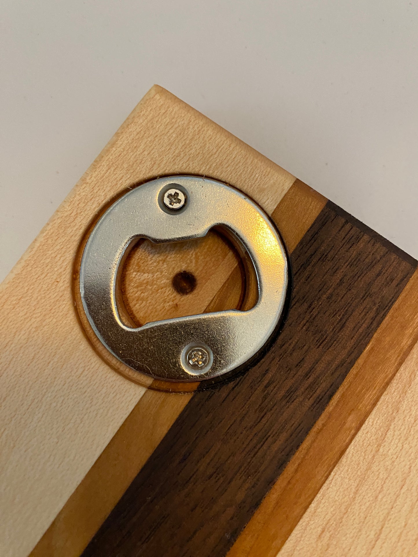 Coaster with built in bottle opener