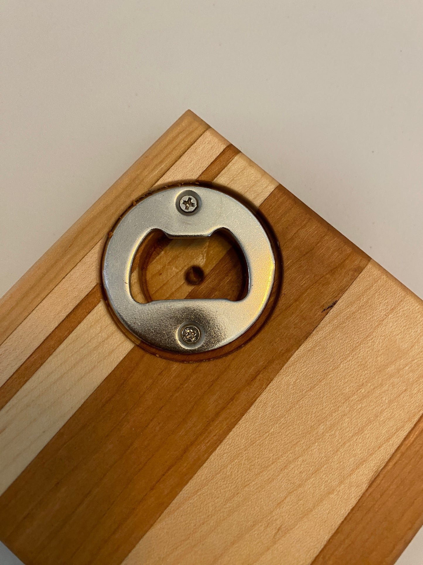 Coaster with built in bottle opener