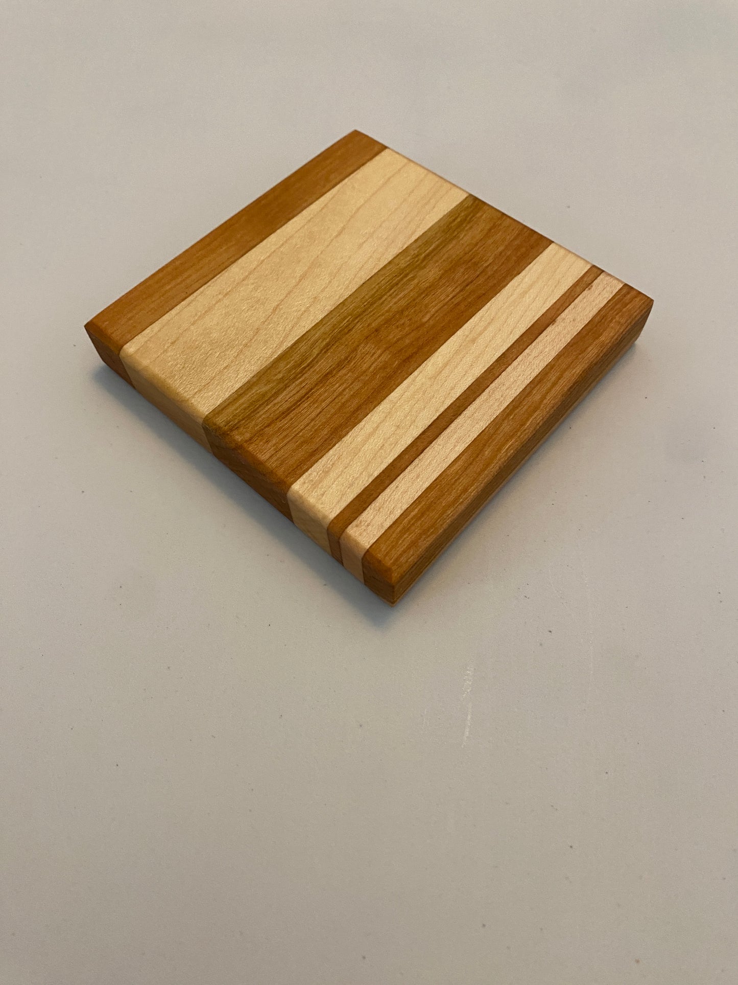 Coaster with built in bottle opener