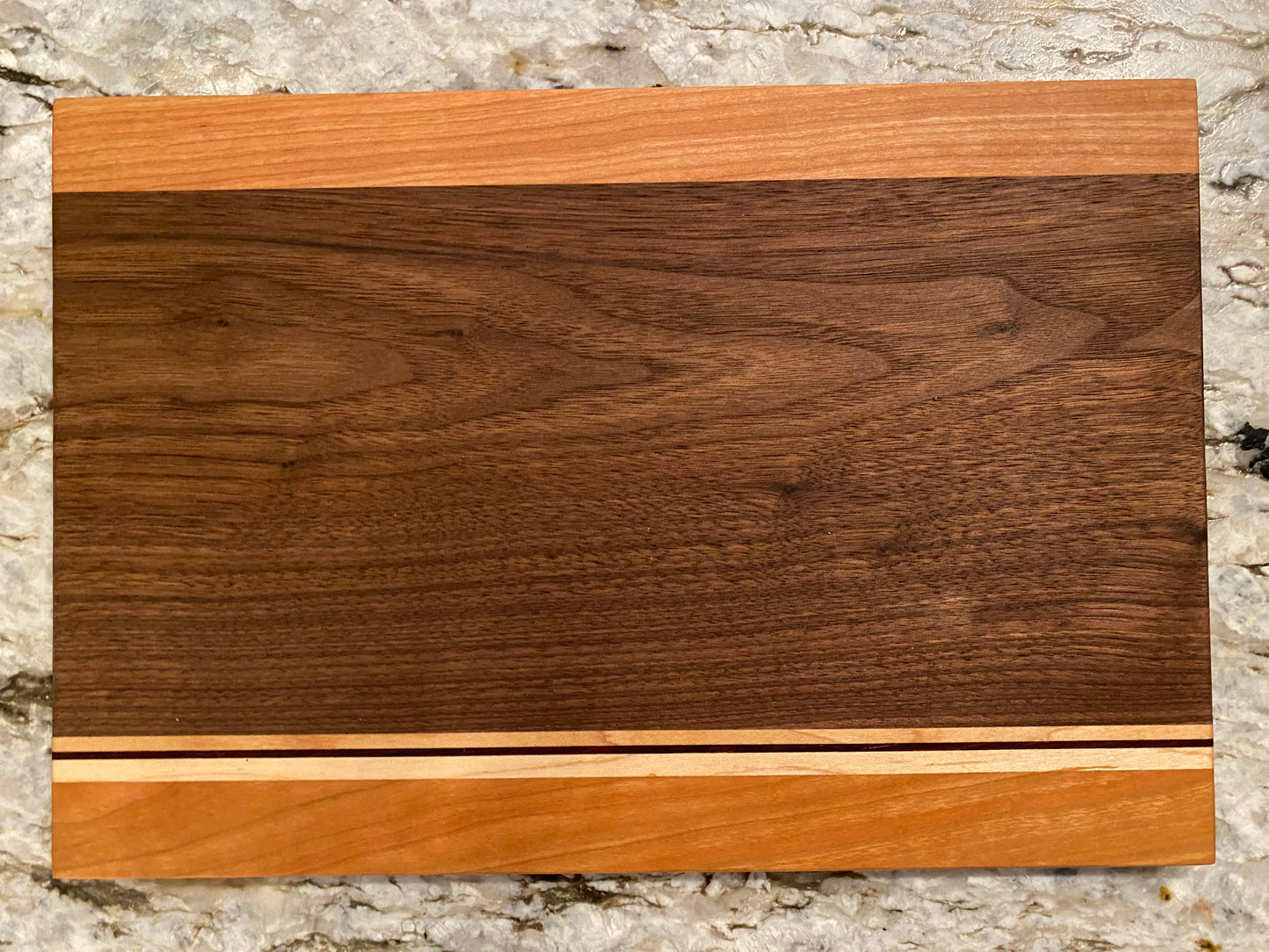 Walnut cutting board with Cherry, Maple, and Padauk highlights